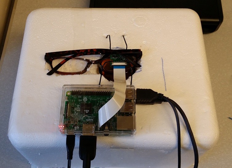Connect the Raspberry Pi and Camera Module and then carefully position the camera on top of the glasses lens