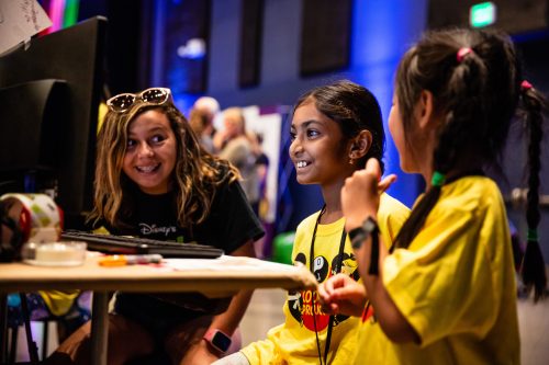 Three excited girls in front of a computer