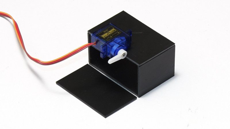 As well as sticky-taping the lid to the rest of the box, double-sided tape is used to position the servo