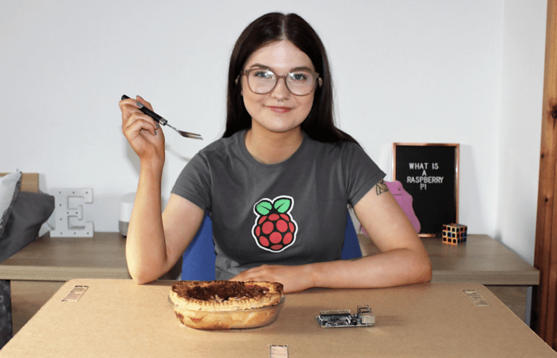 Ellora James in a Raspberry Pi t shirt eating a pie